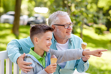 Image showing old man and boy eating ice cream at summer park