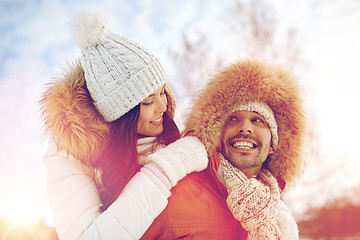 Image showing happy couple having fun over winter background