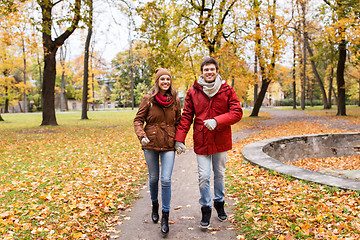 Image showing happy young couple running in autumn park