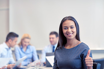 Image showing group of smiling businesspeople meeting in office