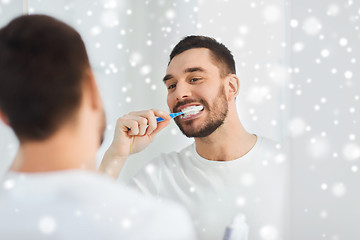 Image showing man with toothbrush cleaning teeth at bathroom