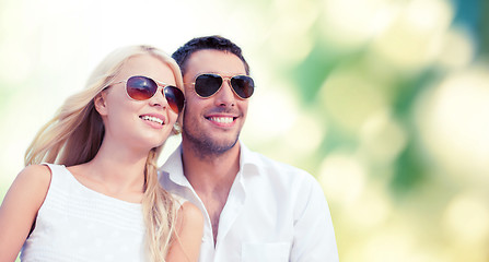 Image showing happy couple in shades over green background