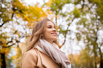 Image showing beautiful happy young woman walking in autumn park