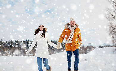 Image showing happy couple running in winter snow