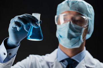 Image showing close up of scientist holding flask with chemical