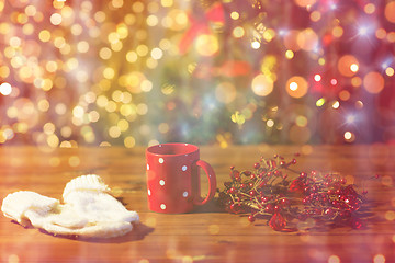 Image showing tea cup with mittens and christmas decoration