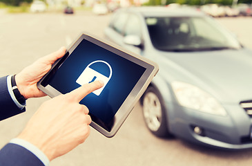 Image showing close up of hands with lock icon on tablet pc