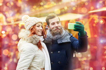 Image showing couple taking selfie with smartphone in old town