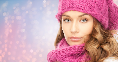 Image showing close up of woman in hat and scarf over lights