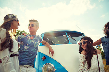 Image showing smiling young hippie friends over minivan car