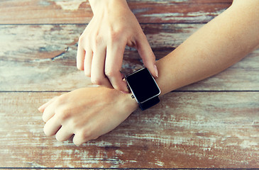 Image showing close up of hands setting smart watch