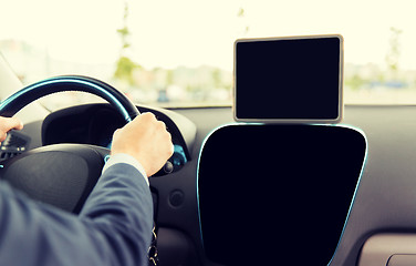 Image showing close up of businessman with tablet pc driving car