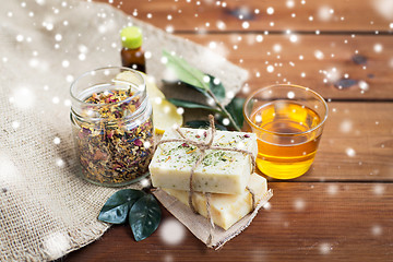 Image showing handmade soap, honey and herbal tea on wood