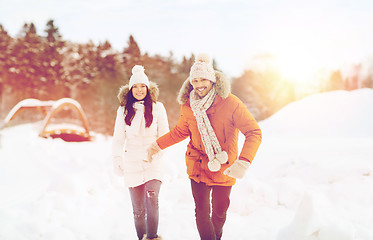 Image showing happy couple running over winter background
