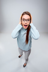 Image showing The smiling young business woman on gray background