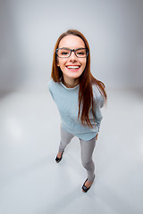 Image showing The smiling young business woman on gray background