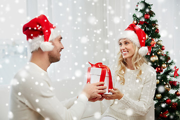 Image showing happy couple at home with christmas gift box