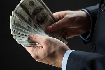 Image showing close up of businessman hands holding money