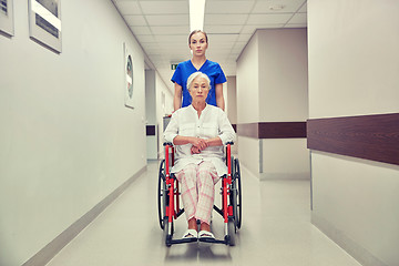 Image showing nurse with senior woman in wheelchair at hospital