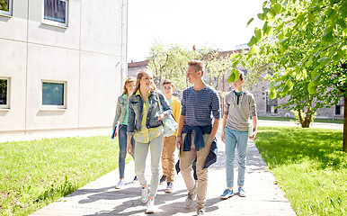 Image showing group of happy teenage students walking outdoors