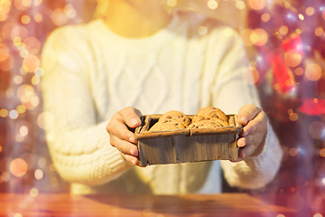 Image showing close up of woman with christmas oat cookies 