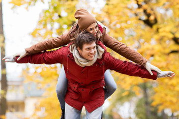 Image showing happy young couple having fun in autumn park