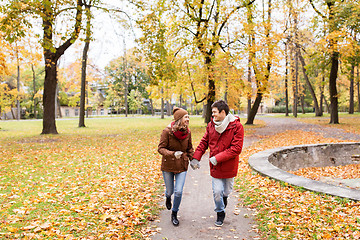 Image showing happy young couple running in autumn park