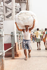 Image showing Man carrying load on the Howrah Bridge