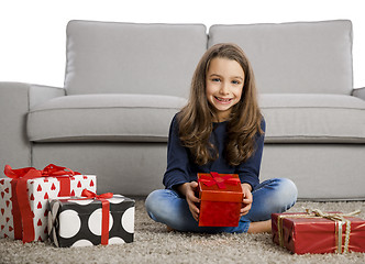 Image showing Little girl opening presents