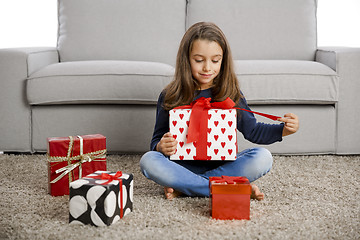 Image showing Little girl opening presents