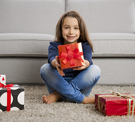 Image showing Little girl opening presents