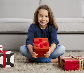 Image showing Little girl opening presents