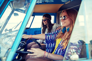 Image showing smiling young hippie women driving minivan car