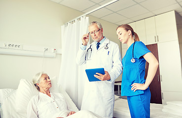 Image showing doctor and nurse visiting senior woman at hospital