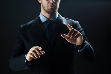 Image showing close up of businessman touching virtual screen