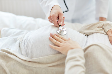 Image showing doctor with stethoscope and pregnant woman