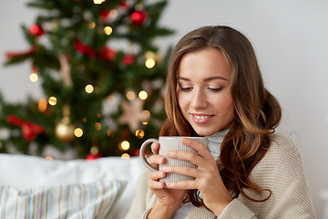 Image showing happy woman with cup of tea at home for christmas