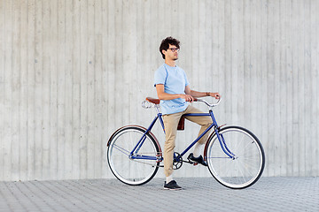 Image showing young hipster man riding fixed gear bike