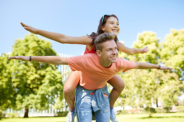 Image showing happy teenage couple having fun at summer park