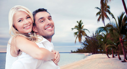 Image showing couple having fun and hugging on beach