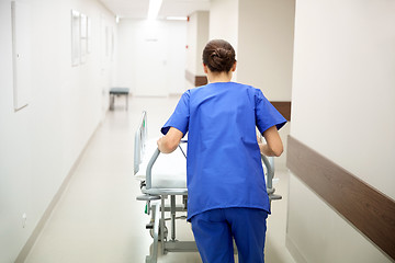 Image showing nurse carrying hospital gurney to emergency room