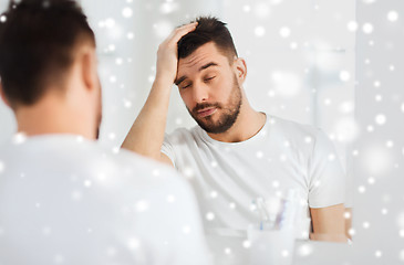 Image showing sleepy young man in front of mirror at bathroom