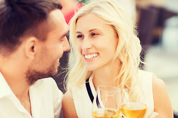 Image showing happy couple clinking glasses at restaurant lounge