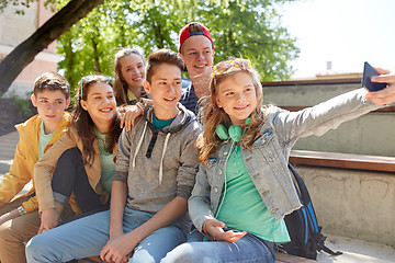 Image showing happy teenage students taking selfie by smartphone