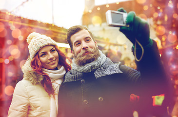 Image showing couple taking selfie with smartphone in old town