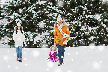 Image showing happy family with sled walking in winter forest