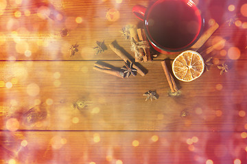 Image showing tea cup with winter spices on wooden table
