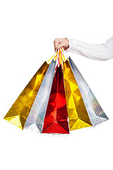 Image showing Womans hand holding colorful shopping bags 