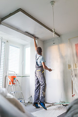 Image showing Plasterer renovating indoor walls and ceilings. Finishing works.