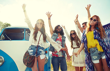 Image showing smiling hippie friends having fun over minivan car
